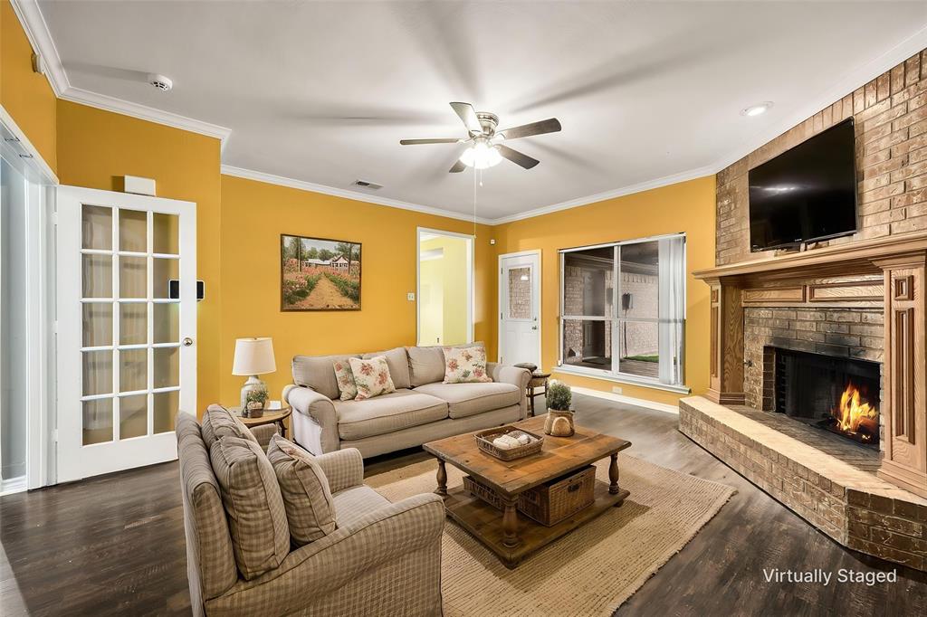 Cozy family room with brick fireplace that has a gas starter for gas logs.