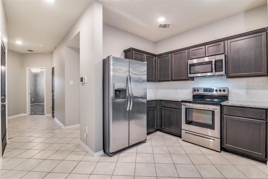 Kitchen open to living room, refrigerator to convey