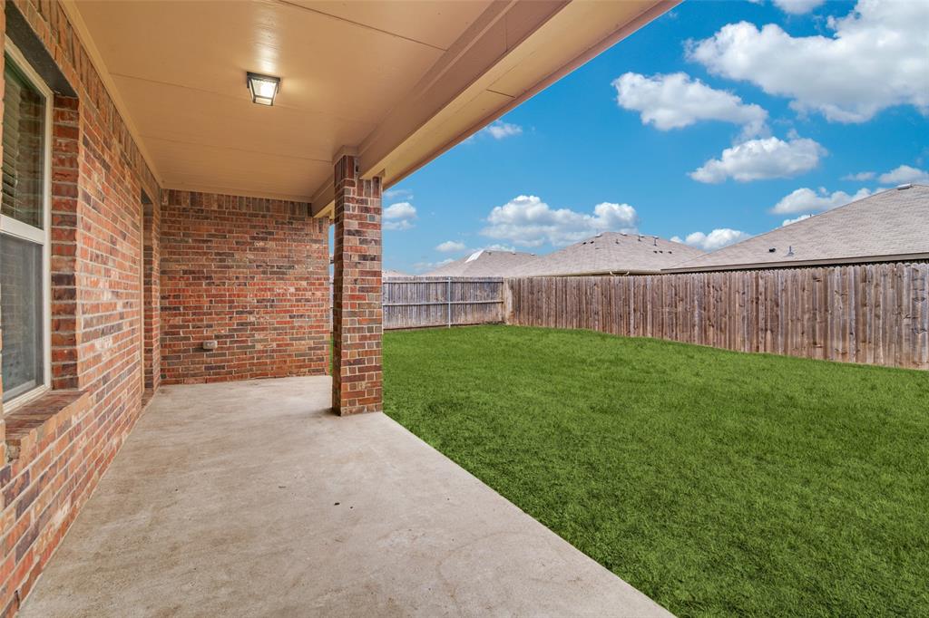 Covered patio and fenced in backyard Covered patio and fenced in backyard