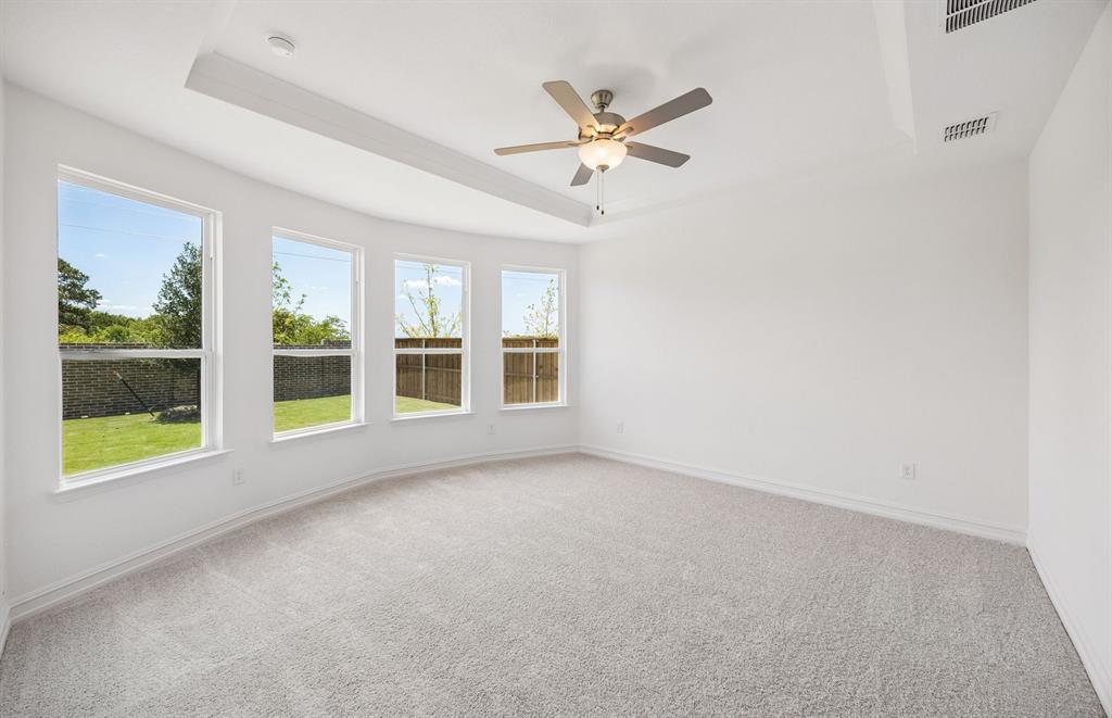 Spacious primary suite with bay windows