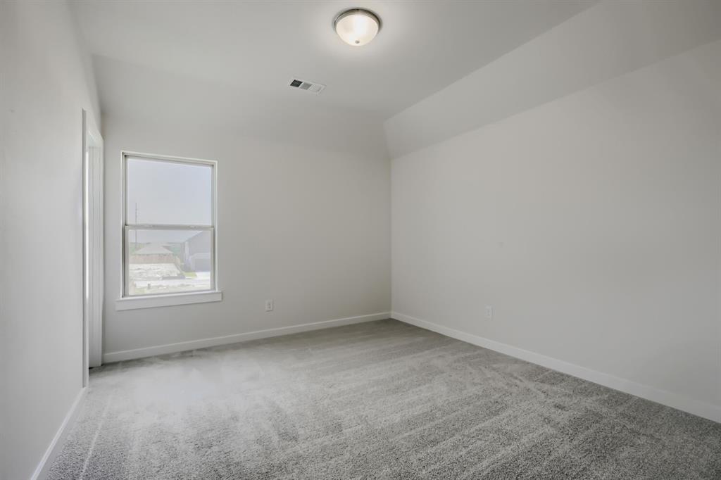 Room featuring light gray carpet flooring, white painted walls, and a single window with white trim