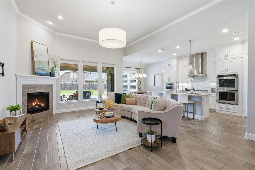 Open-concept living area with wood-finish flooring and a contemporary fireplace