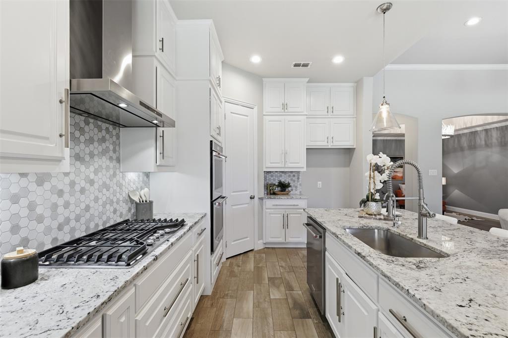 Modern kitchen featuring white cabinetry and light-toned countertops
