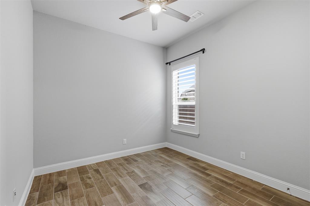 First Floor Secondary Bedrooms: Neutral paint tones complemented by wood-finish flooring