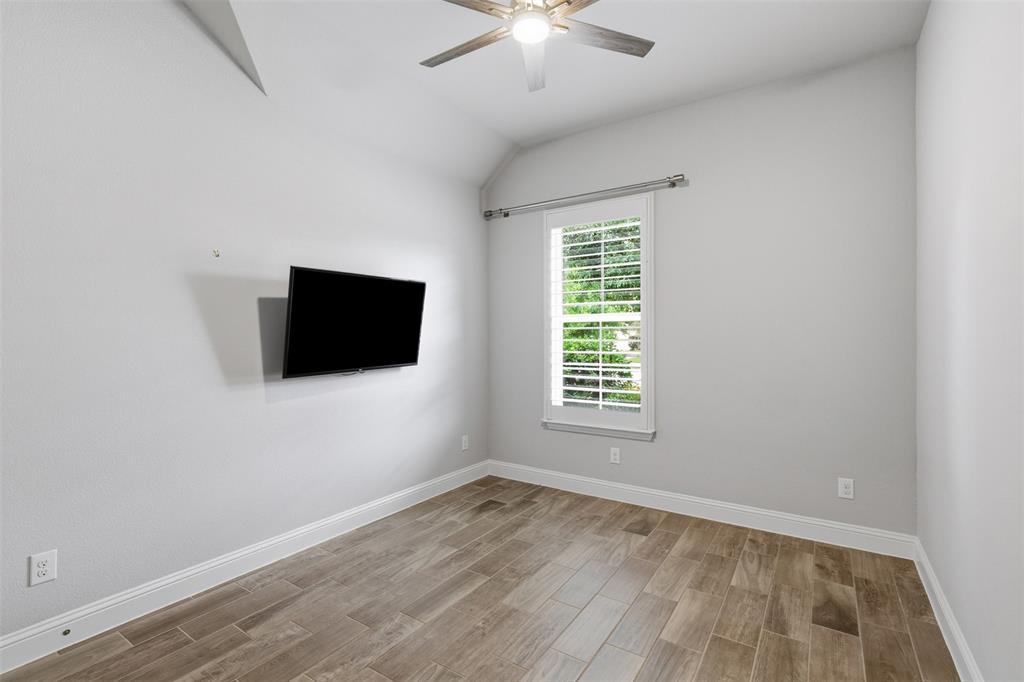 1st floor secondary bedroom with vaulted ceiling and plantation shutters