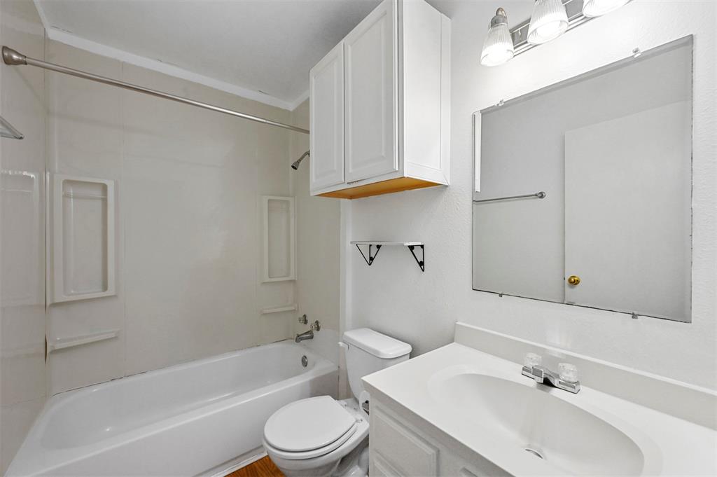Full bathroom with shower / bathtub combination, vanity, and toilet