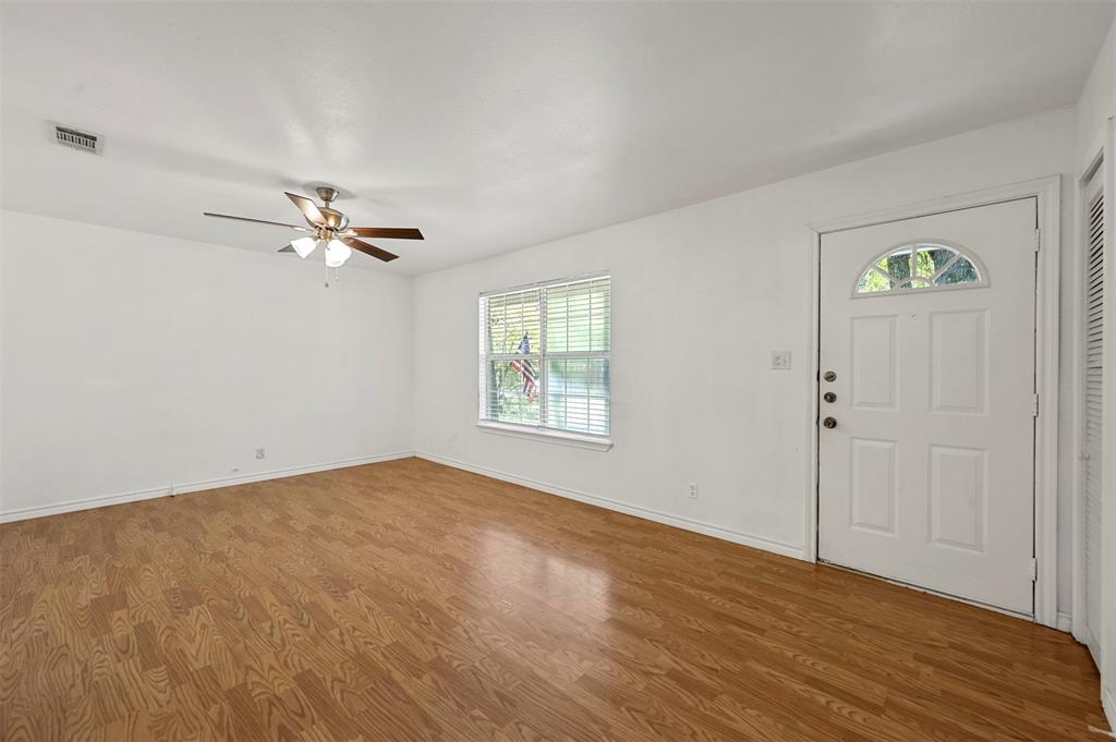 Foyer entrance featuring ceiling fan and wood-type flooring