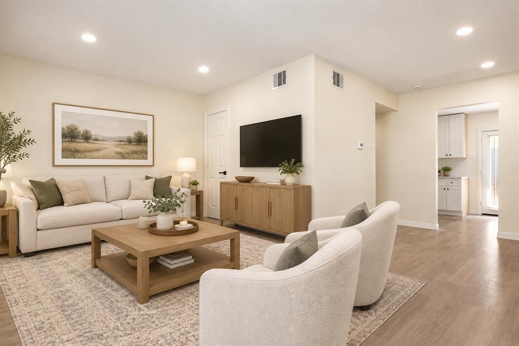 Recessed lighting illuminates an open-concept living area with wood-finish flooring Recessed lighting illuminates an open-concept living area with wood-finish flooring