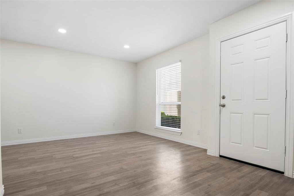 Entryway featuring a paneled door, wood-finish flooring, recessed lighting, and a window with blinds