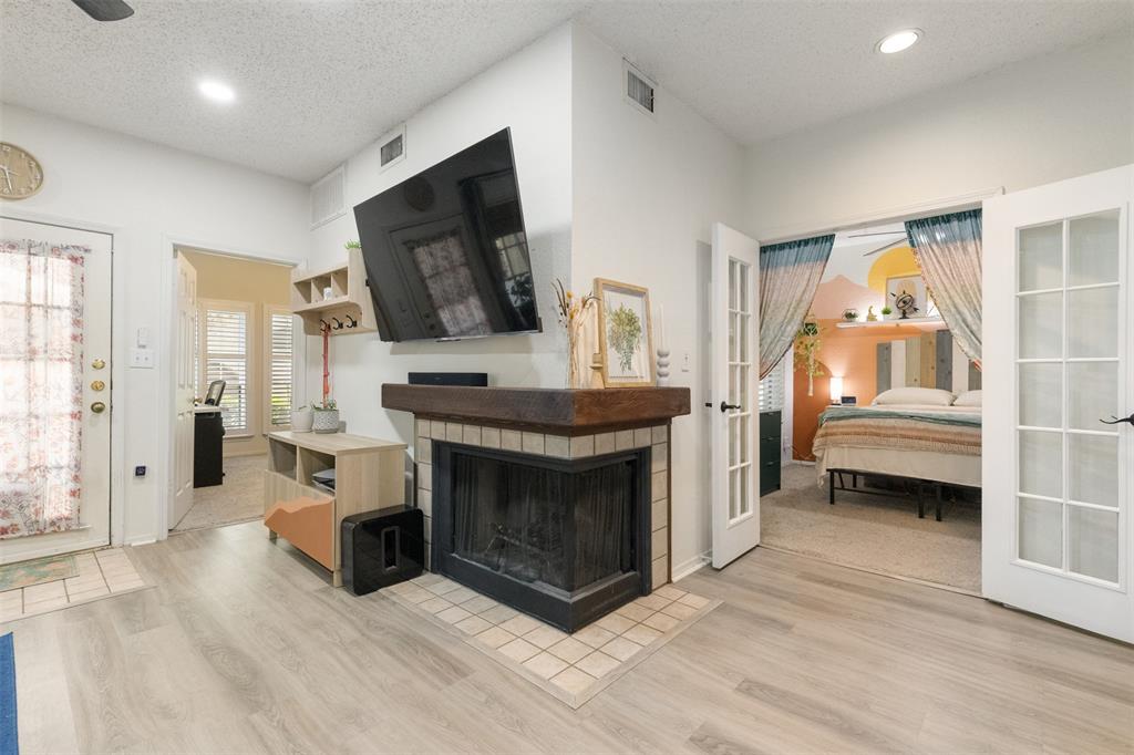 cozy corner wood burning fireplace centrally located between living and dining spaces