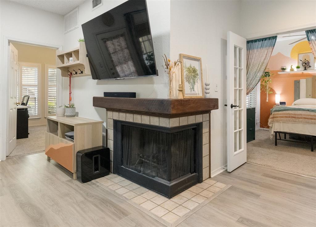 cozy corner wood burning fireplace centrally located between living and dining spaces