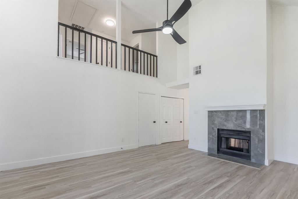 Vaulted ceilings complementing a modern black ceiling fan