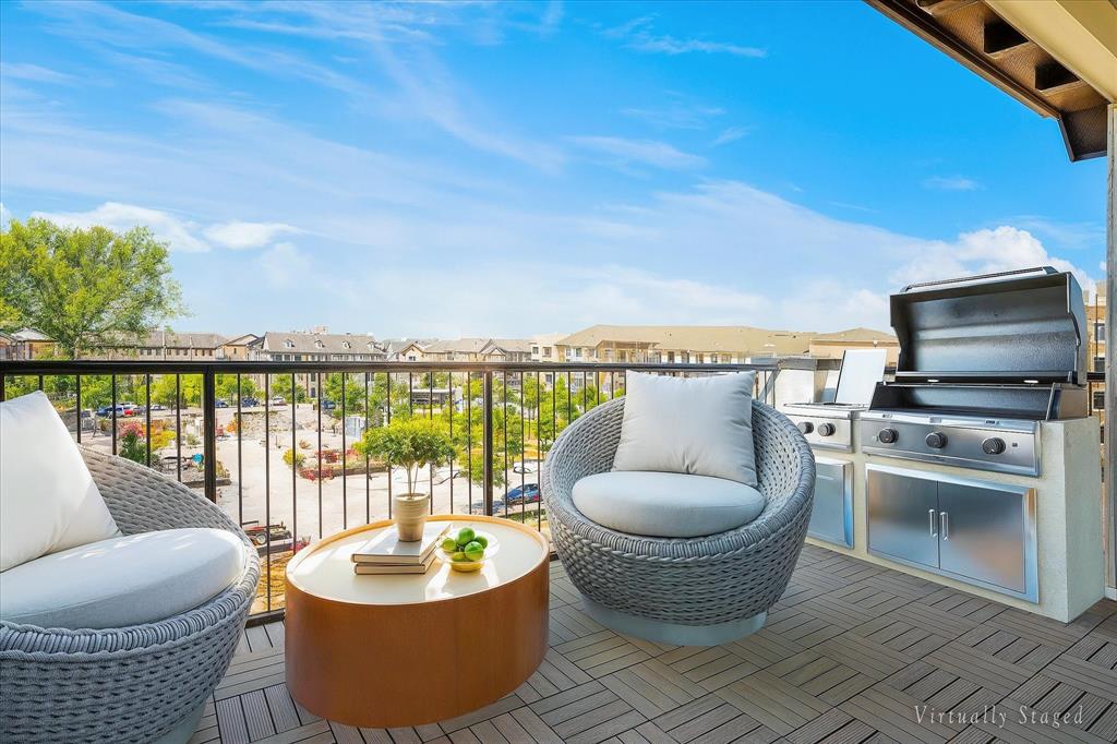 Spacious balcony featuring tile flooring and a built-in outdoor kitchen with a stainless steel grill