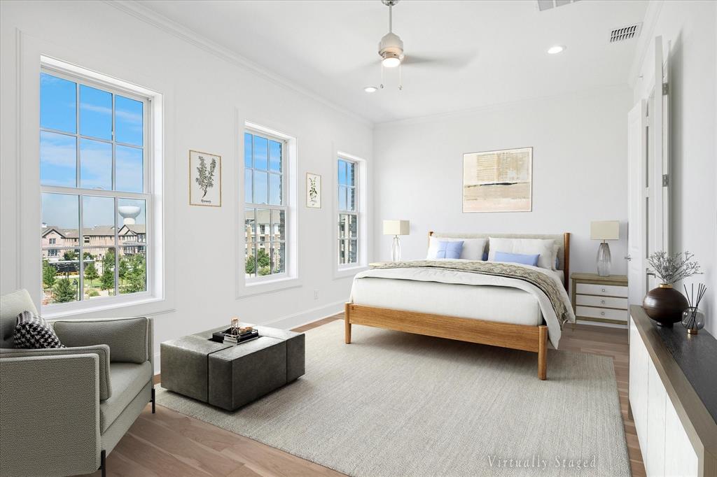 Spacious room featuring multiple large sash windows, light wood-finish flooring, recessed lighting, a ceiling fan, and a light-colored area rug