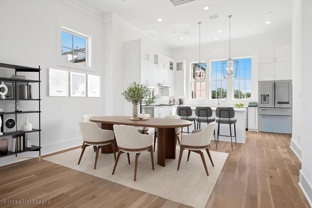 Open-concept living space with wide plank wood-finish flooring
