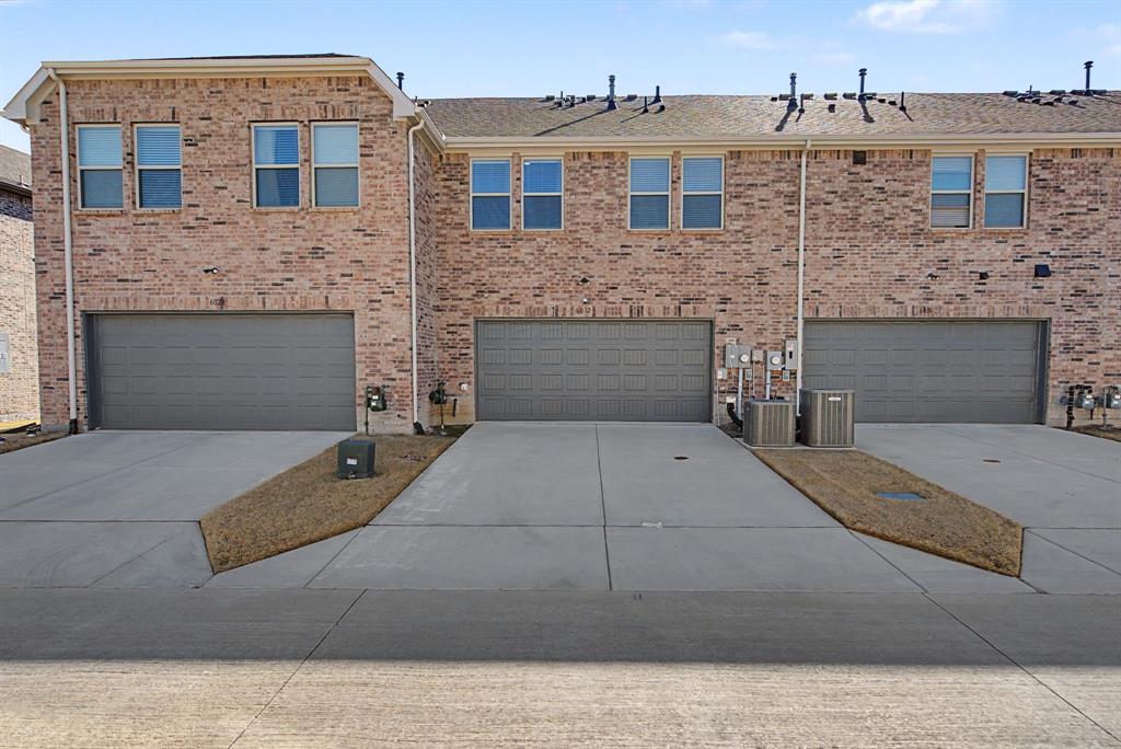 Brick facade townhome with individual garage and dedicated driveway