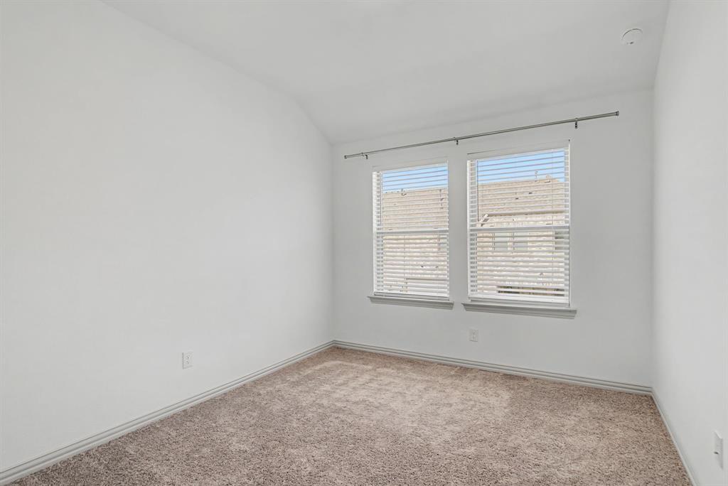 Neutral white walls, plush carpet flooring, and white trim