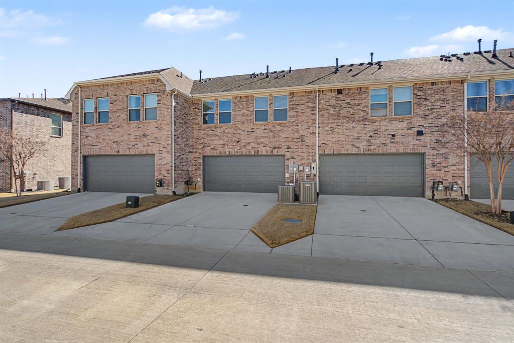 Brick exterior townhome with an attached two-car garage