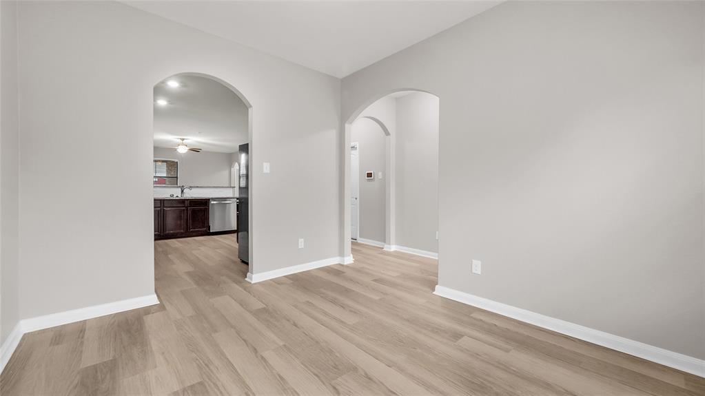 View from dining area to the kitchen and main entry. View from dining area to the kitchen and main entry.