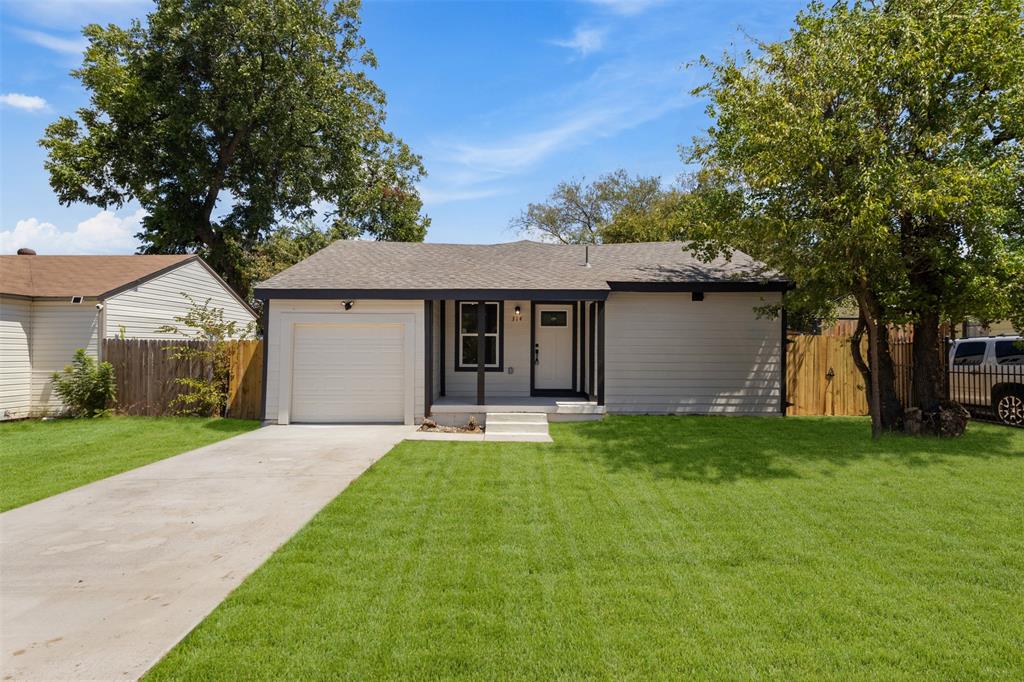 Single-story residence featuring a front-facing garage, covered entryway, and a concrete driveway