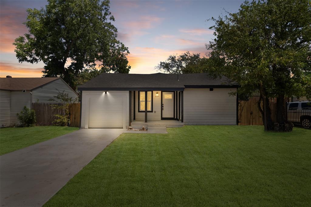 Contemporary single-story residence with a dark asphalt shingle roof, light-colored siding, and a concrete driveway