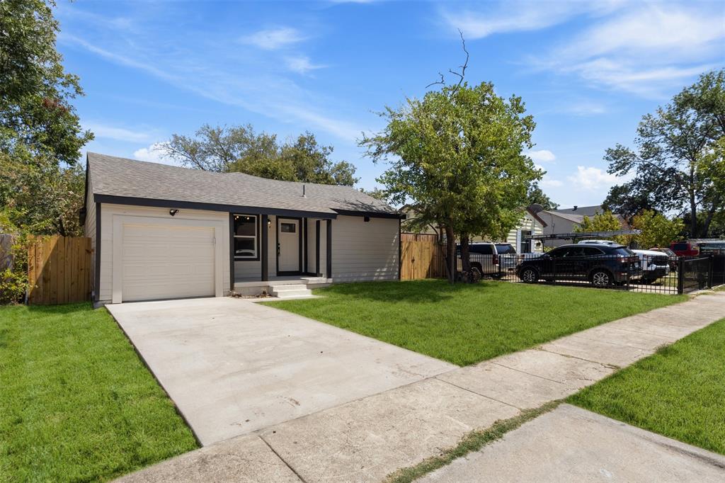 Contemporary exterior with light siding, dark trim, an attached garage, a concrete driveway, and a manicured lawn