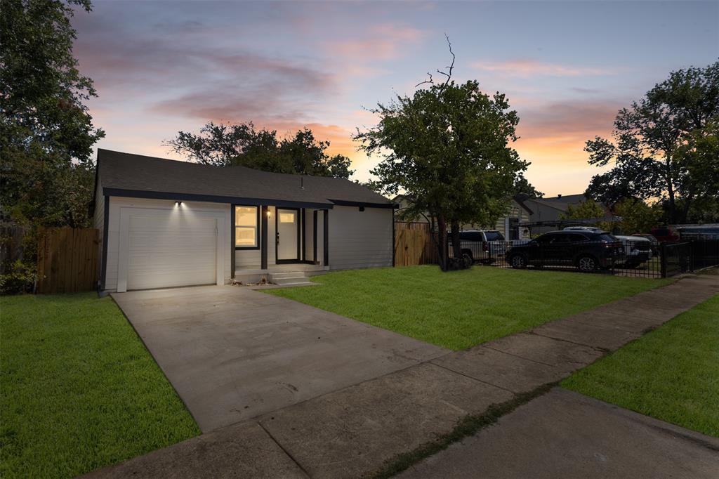 Contemporary exterior with a dark-pitched roof, white garage door, and a concrete driveway