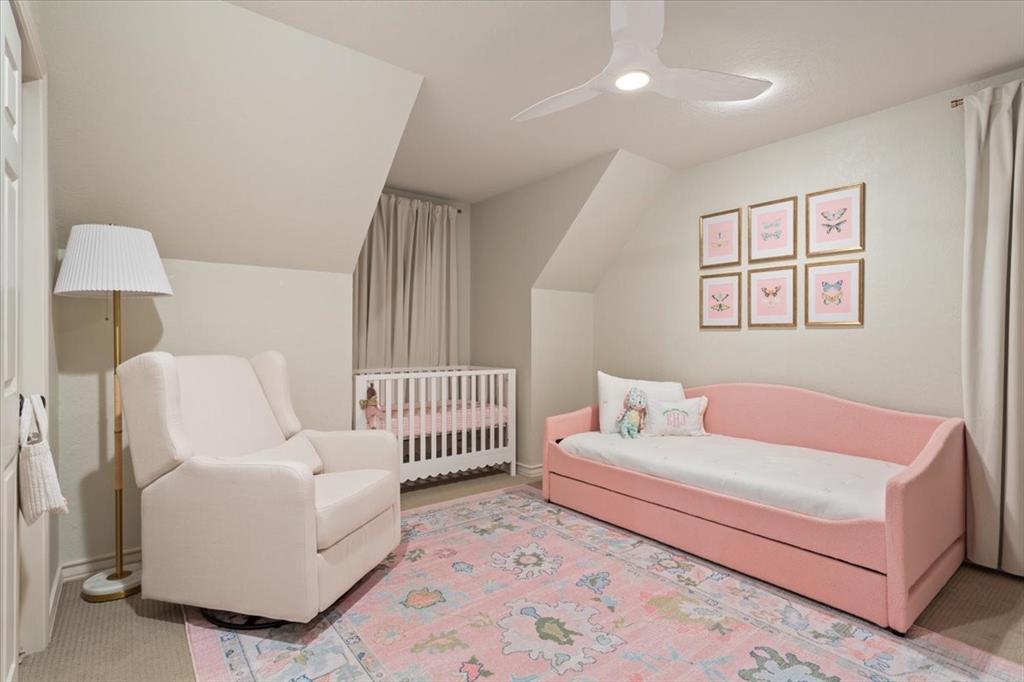 Upstairs room featuring sloped ceilings, light-toned walls, and carpeted flooring