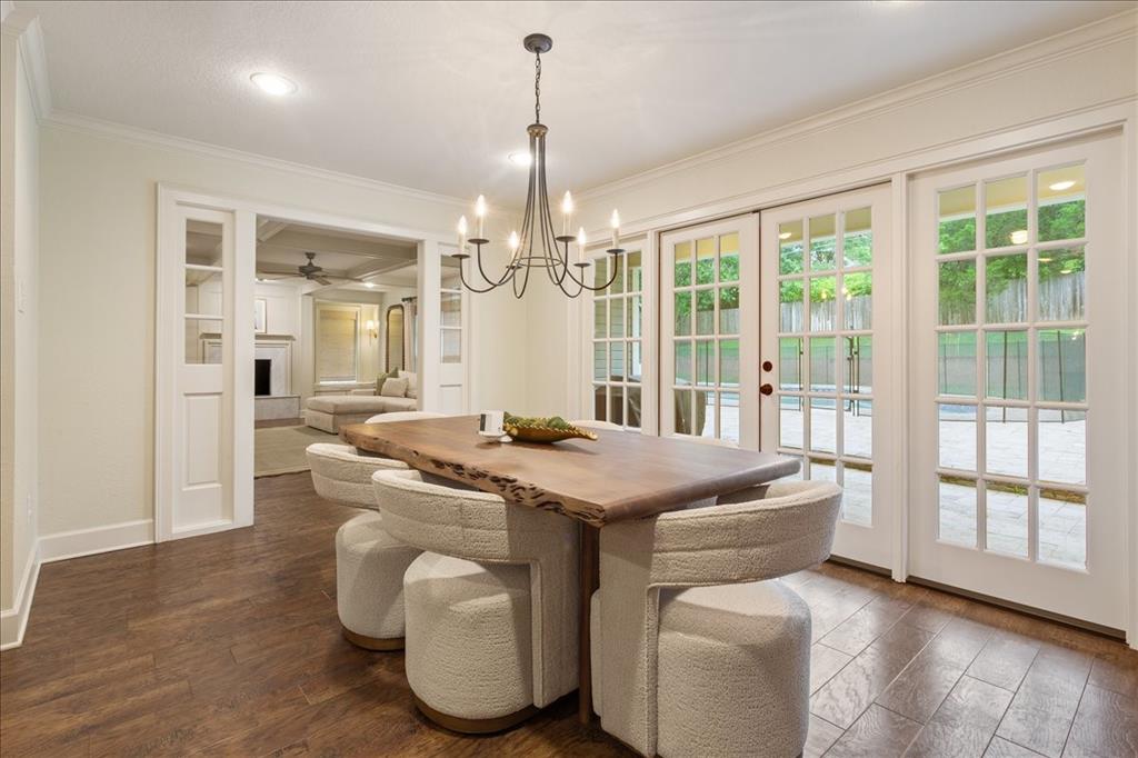Dining area featuring wood-finish flooring and a contemporary chandelier