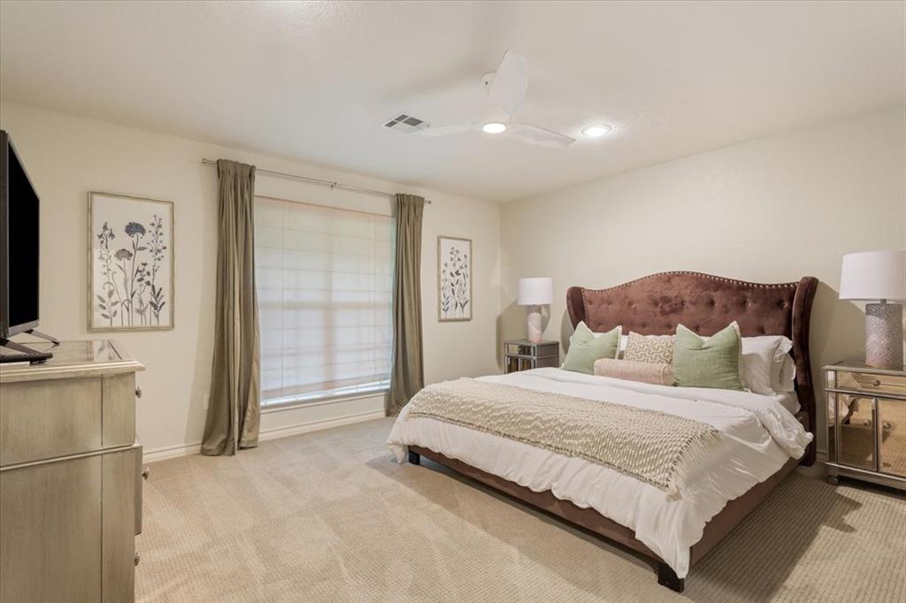 Upstairs carpeted bedroom with a large window featuring blinds and drapes, a ceiling fan with integrated lighting, and recessed ceiling lights
