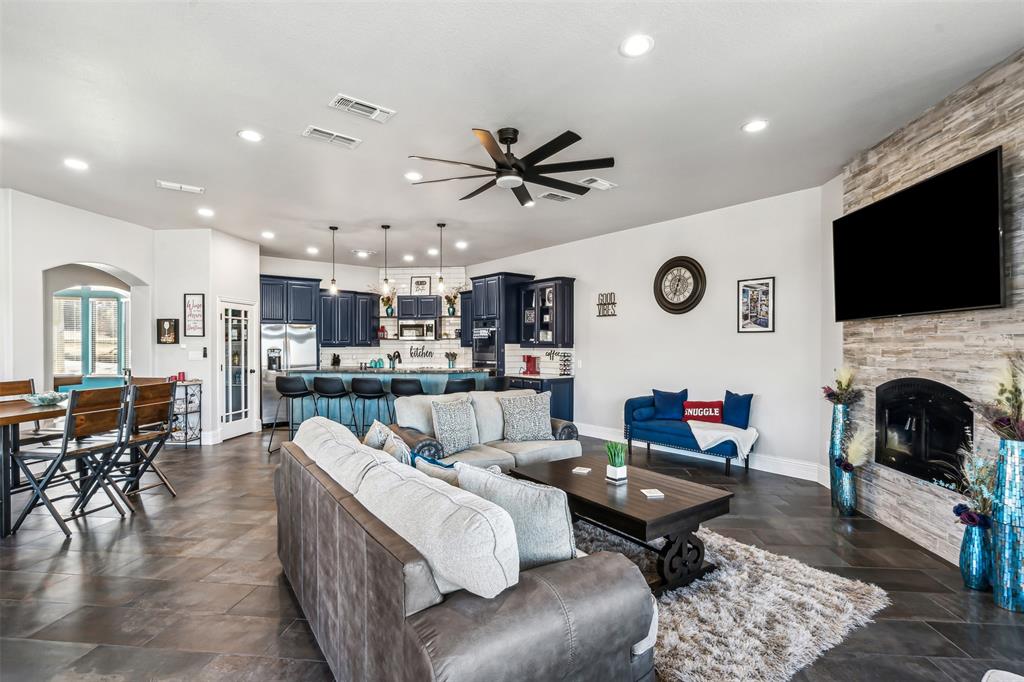 Open-concept living space featuring expansive tile flooring and recessed lighting