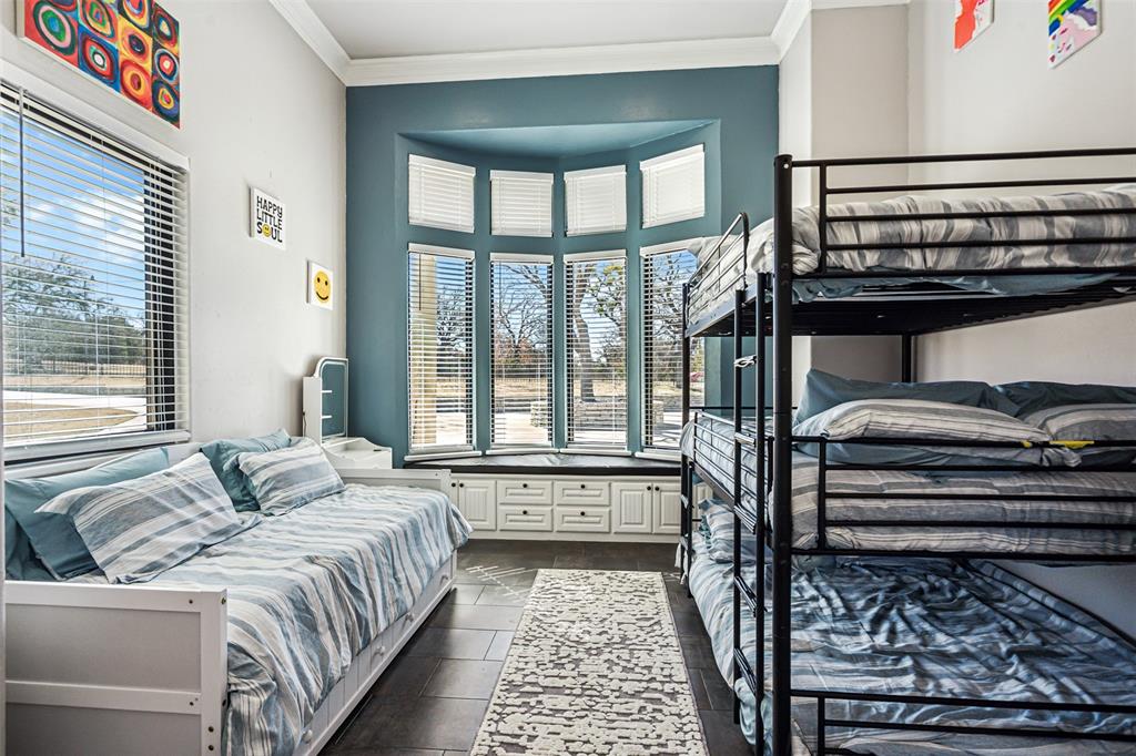 Room featuring a bay window with a built-in window seat and storage cabinetry