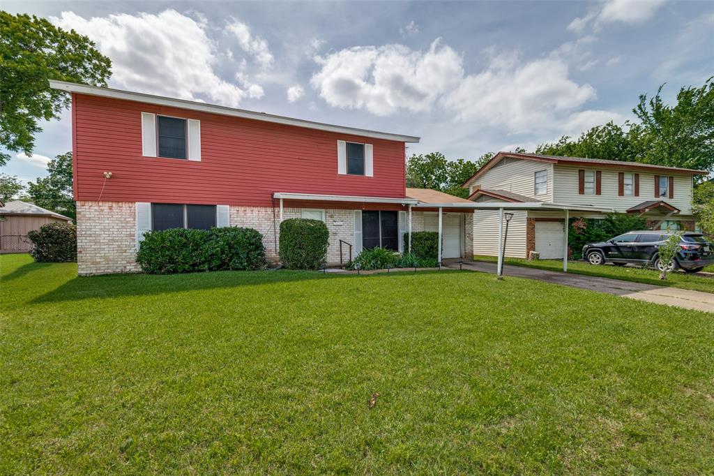 Two-story residence featuring red siding and a white brick facade