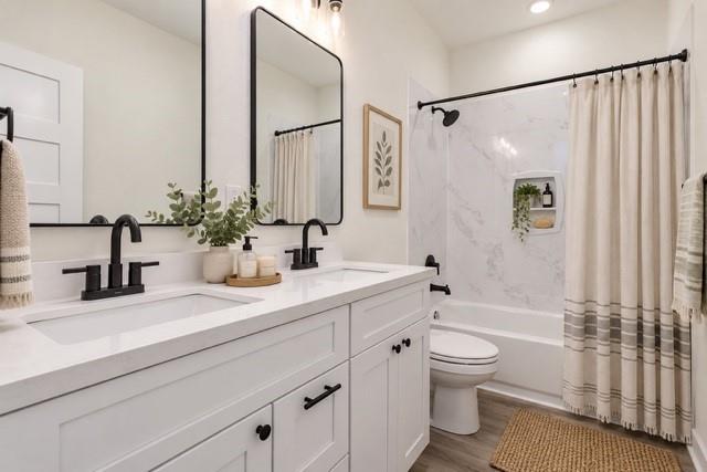 Virtual staging - Double vanity with white cabinetry and integrated sinks, matte black fixtures, framed mirrors, and a shower-over-tub with a built-in niche Virtual staging - Double vanity with white cabinetry and integrated sinks, matte black fixtures, framed mirrors, and a shower-over-tub with a built-in niche