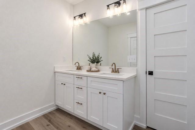Virtual staging - Dual vanity with white cabinetry, bronze-finish faucets, and an expansive mirror Virtual staging - Dual vanity with white cabinetry, bronze-finish faucets, and an expansive mirror