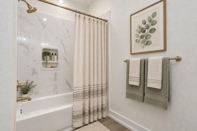 Virtual staging -Bathtub with a built-in shower niche, brushed bronze fixtures, and a white marble-look shower surround Virtual staging -Bathtub with a built-in shower niche, brushed bronze fixtures, and a white marble-look shower surround