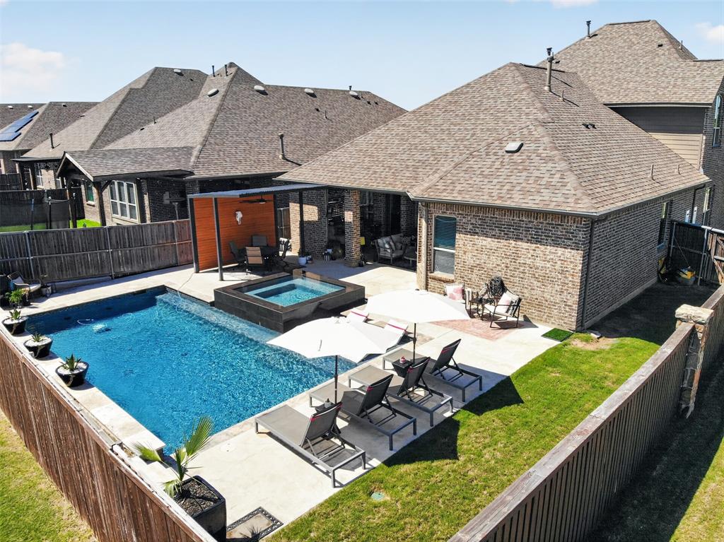 Aerial perspective shows the corner lot, pool, patio and thoughtfully designed backyard.