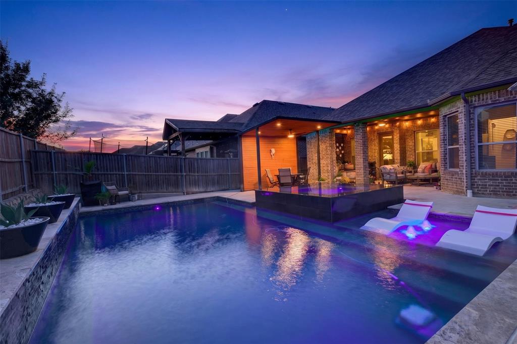 Resort-style pool and spa create a striking backdrop for evening entertaining.