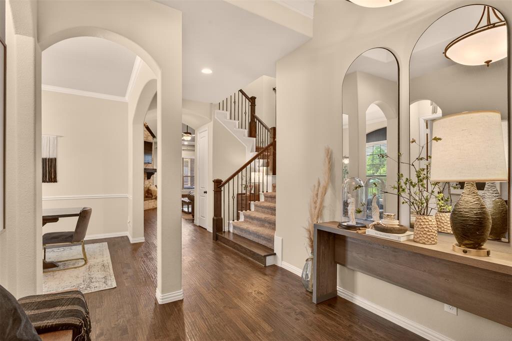 Welcoming entry introduces the home’s wood flooring, architectural details and open layout.