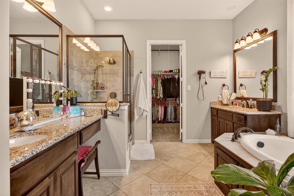 Primary bathroom features dual vanities, generous storage and a spacious layout.