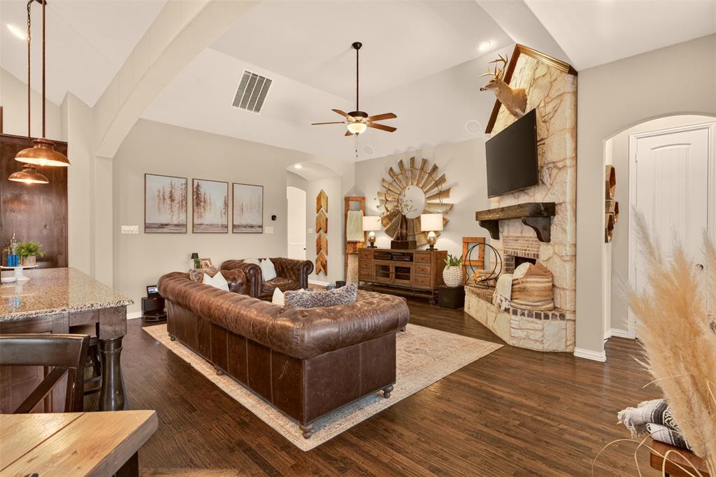 Open living area offers abundant seating space and views toward the kitchen and breakfast area.