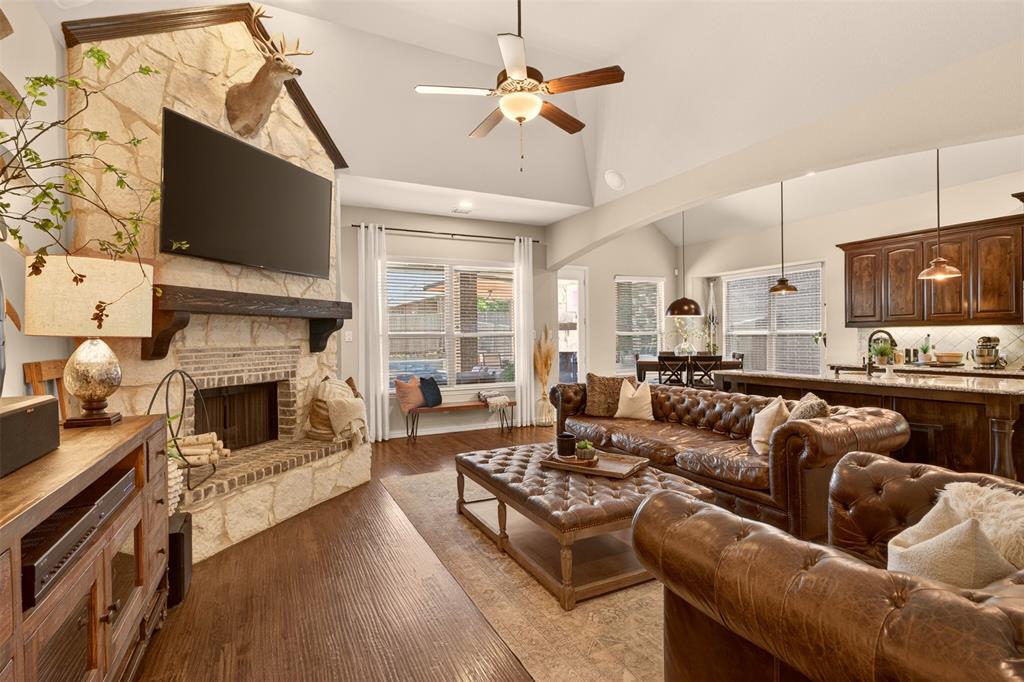 Spacious living room features a fireplace, built-ins and an easy connection to the kitchen.