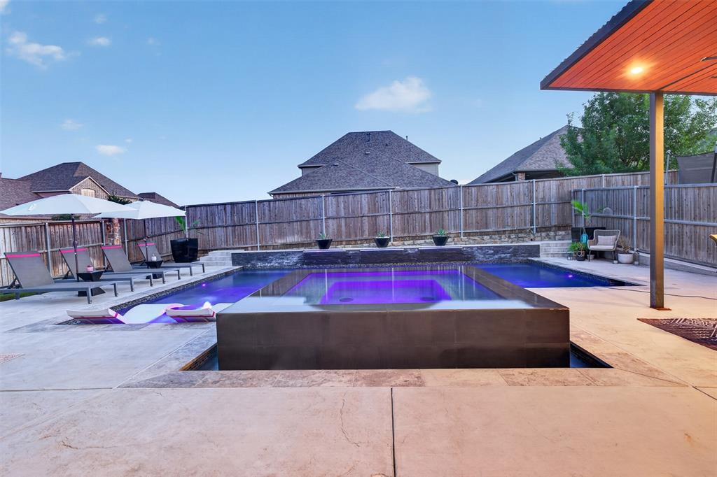 Sun shelf, spa and surrounding deck provide multiple ways to enjoy the backyard.