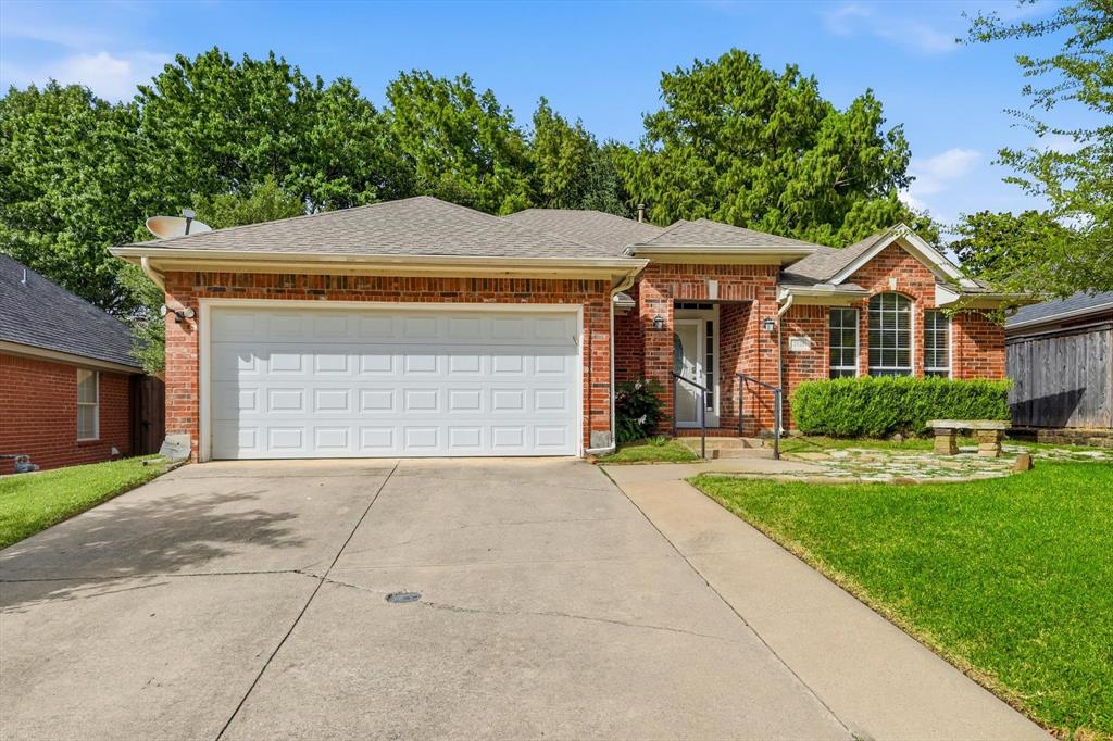 Brick exterior with a gabled roof and a two-car garage
