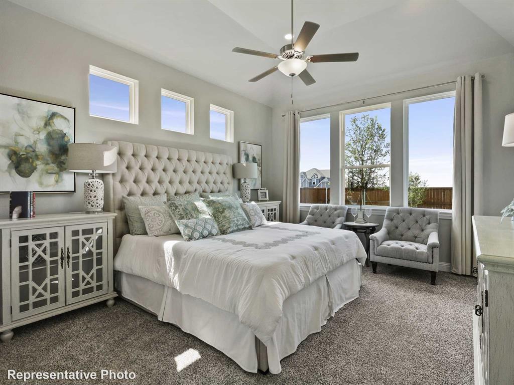 Spacious interior featuring a coffered ceiling, ceiling fan, and carpet flooring