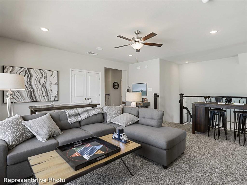 Spacious bonus room featuring plush carpet flooring, recessed lighting, and a ceiling fan