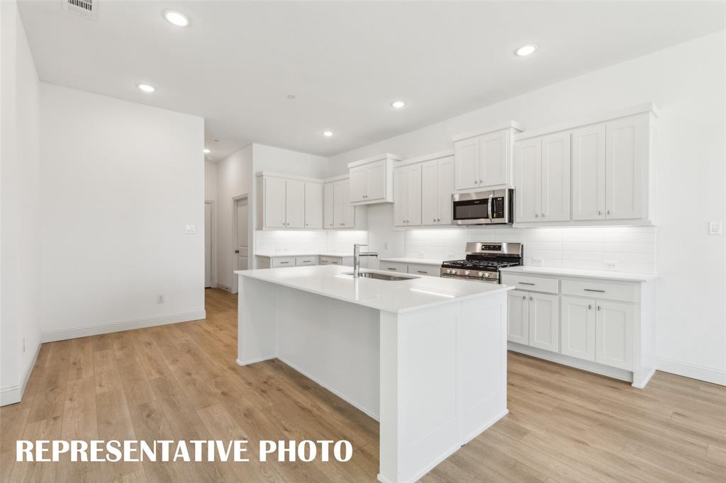 The oversized kitchen island creates the prefect place for friends and family to gather. REPRESENTATIVE PHOTO The oversized kitchen island creates the prefect place for friends and family to gather. REPRESENTATIVE PHOTO