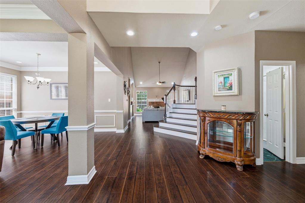 Engineered wood, stairs with white risers. Stacked formals to left, Study or BdRm 2 with French doors to right, Full Hall Bath at door to right. Primary Suite to right. Engineered wood, stairs with white risers. Stacked formals to left, Study or BdRm 2 with French doors to right, Full Hall Bath at door to right. Primary Suite to right.