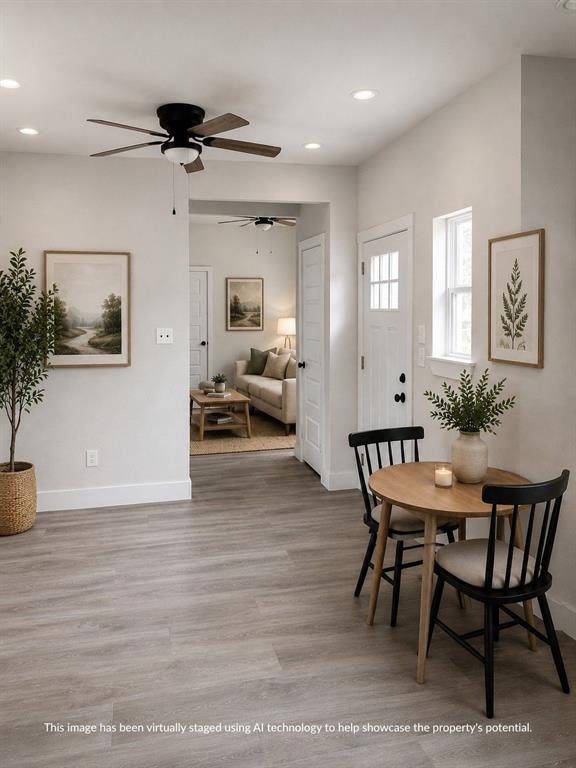 Open-concept living space featuring wood-finish flooring, recessed lighting, and a ceiling fan