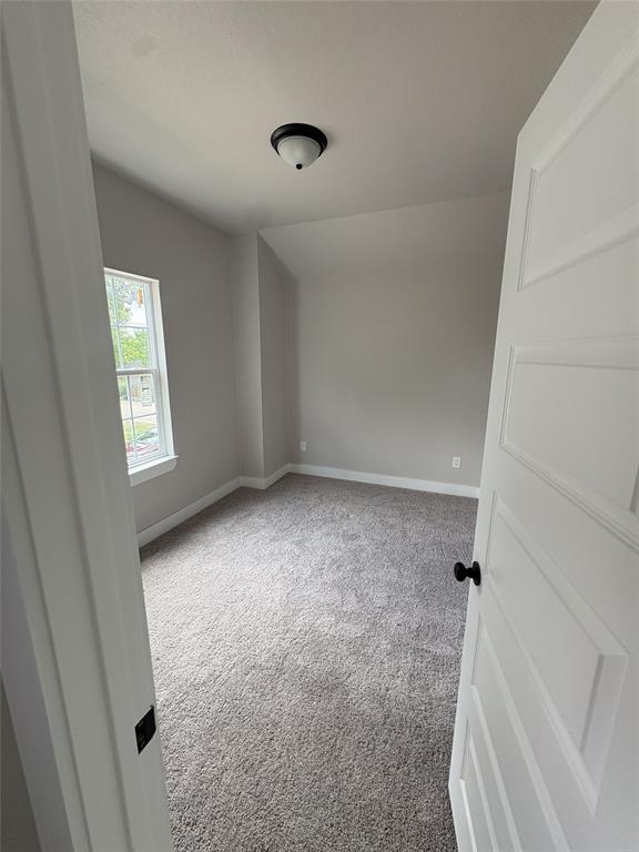 Neutral wall paint, plush grey carpeting, and white trim create a clean aesthetic